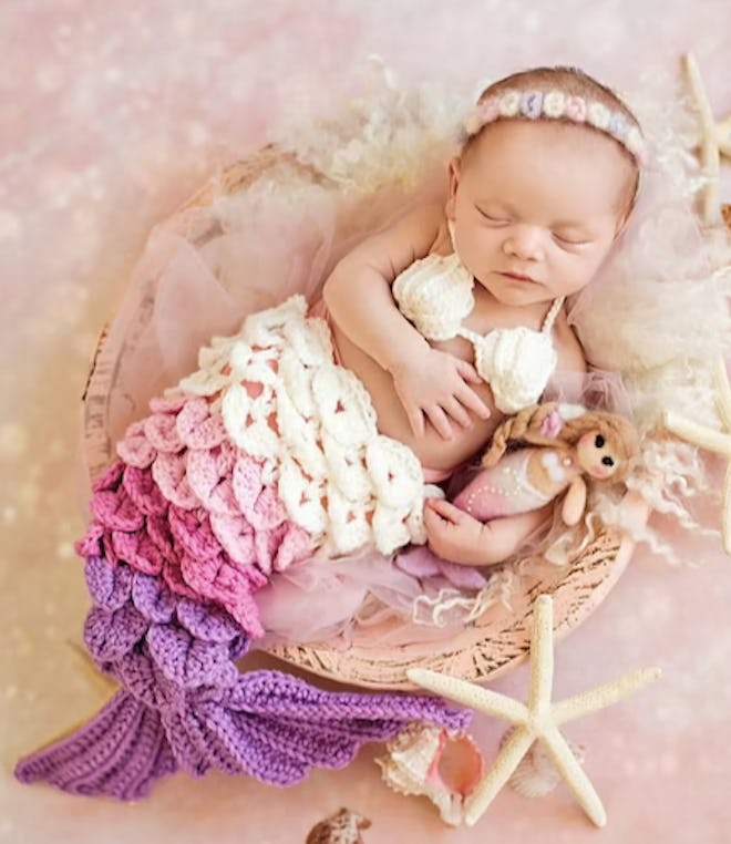 Newborn wearing a mermaid costume