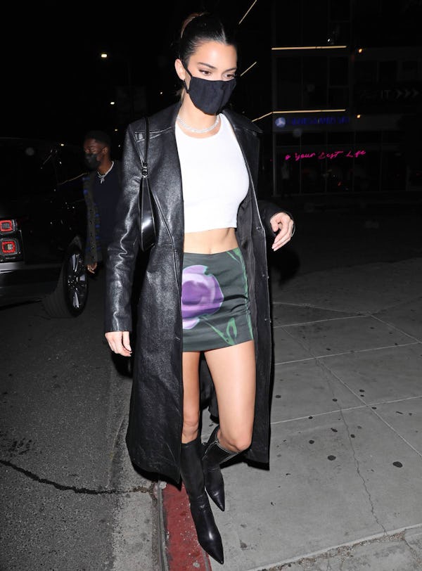 Kendall Jenner in a leather trench, mini skirt and knee-high boots