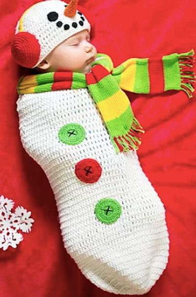 Newborn wearing a snowman costume