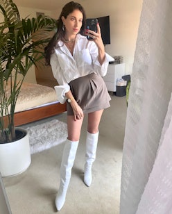 Rebecca Iloulian wearing a miniskirt with white knee-high boots