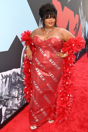 Lizzo in red gown with the words "Siren" on it. 