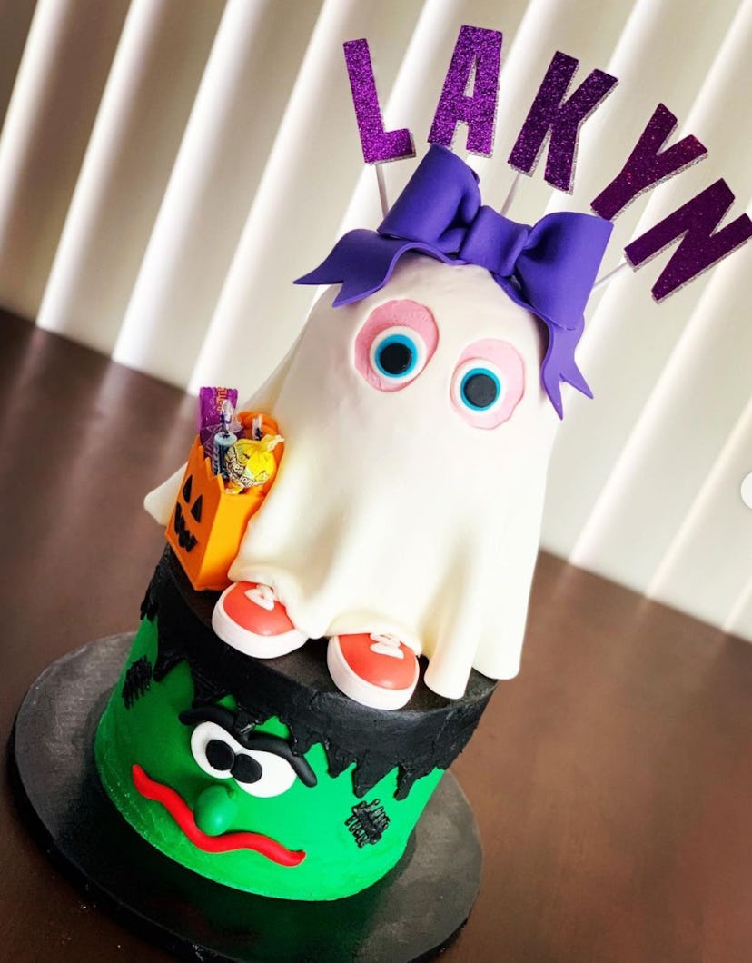 Frankenstein head cake with a ghost trick-or-treater layered on top