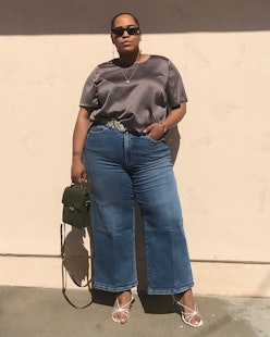 Influencer and 11 Honoré founder Danielle Williams-Eke wears flared jeans a silky top on Instagram.