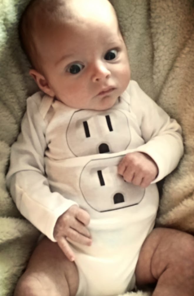 Baby wearing electrical outlet onesie