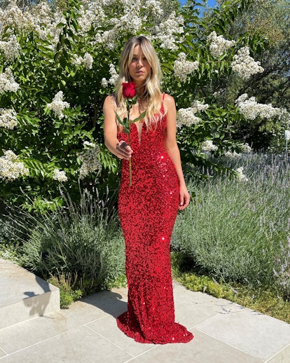 Kaley Cuoco as a contestant from 'The Bachelorette' wearing a red dress and holding a red rose