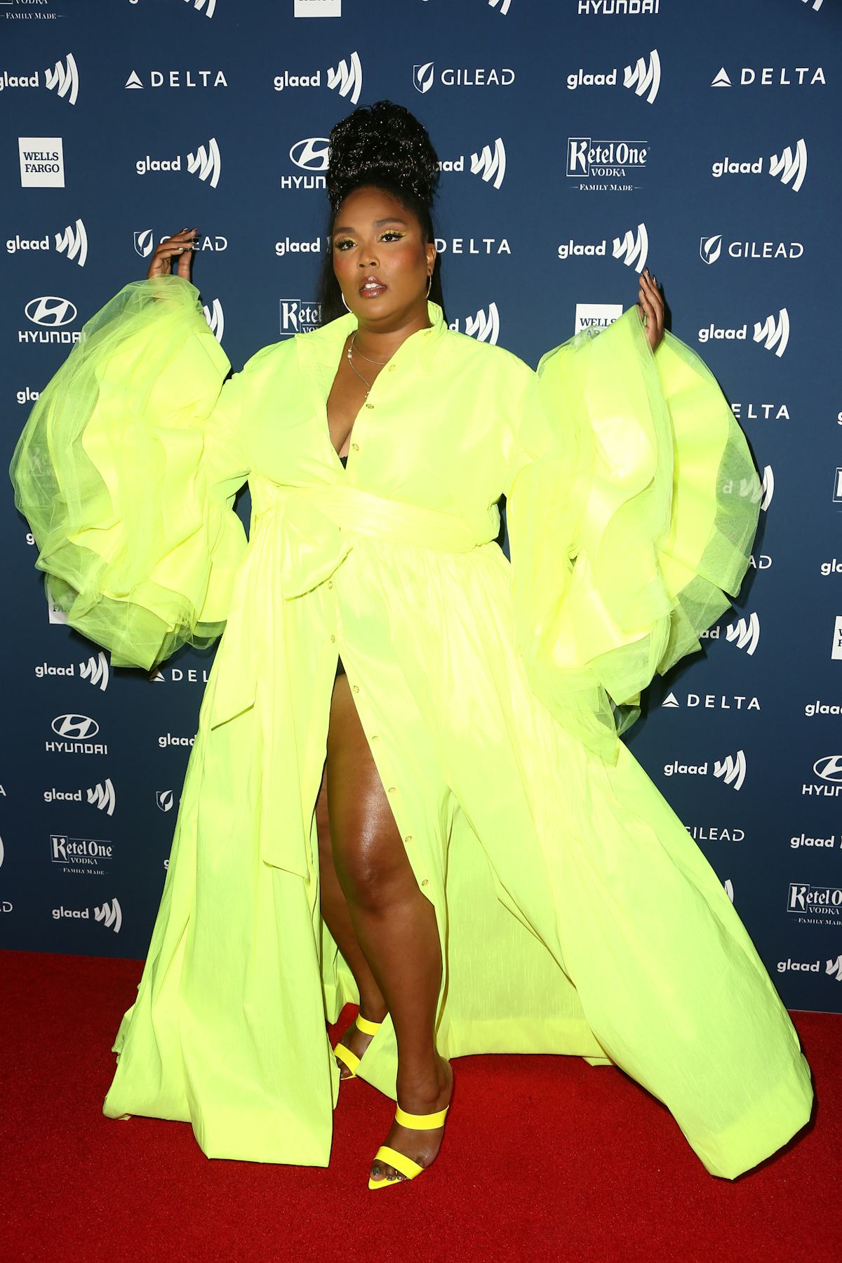 Lizzo in a neon green dress. 