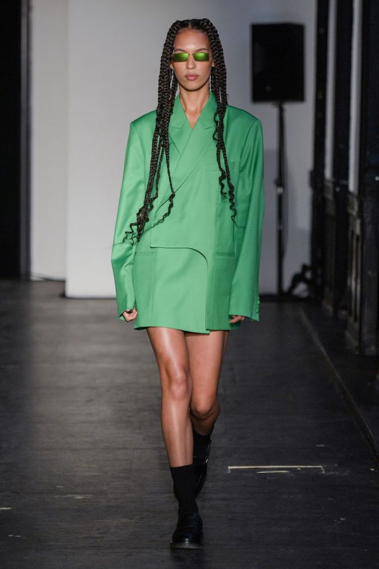 A model in a green blazer dress and sunglasses by Soeren Le Schmidt