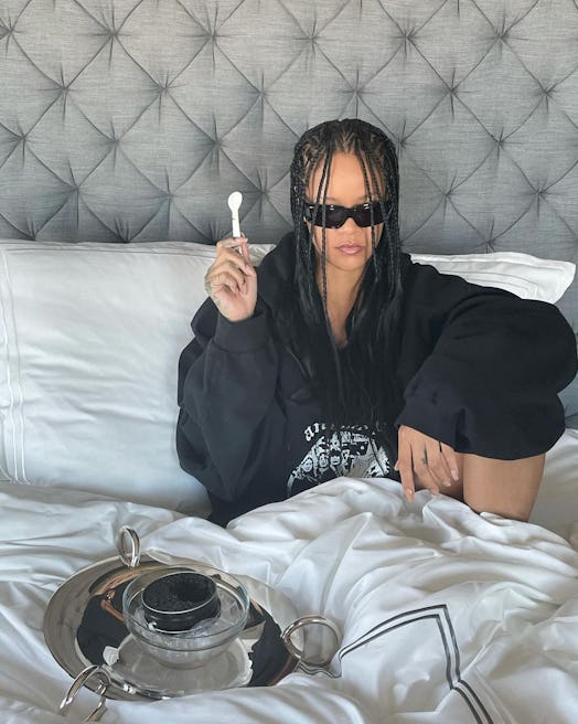 Rihanna in hotel bed with feed-in braids