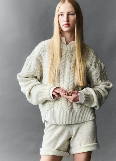 A model in a beige knit sweater and matching shorts by The Garment 