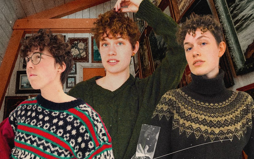 Three male models in a cottage house posing in warm and cozy sweaters.