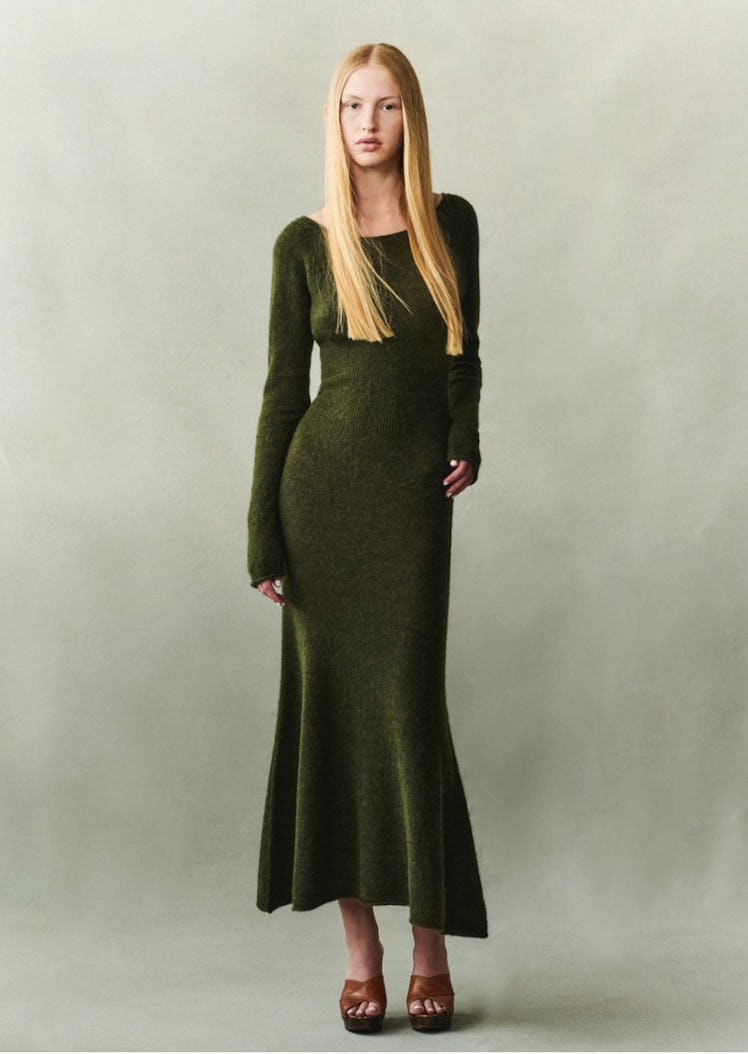 A model in a dark green knit dress by The Garment 