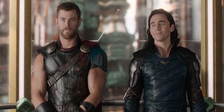 Thor and Loki stand side by side in Thor: Ragnarok.
