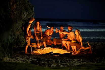 The Pogues at the end of 'Outer Banks' Season 2, roasting marshmallows after getting stranded on an ...