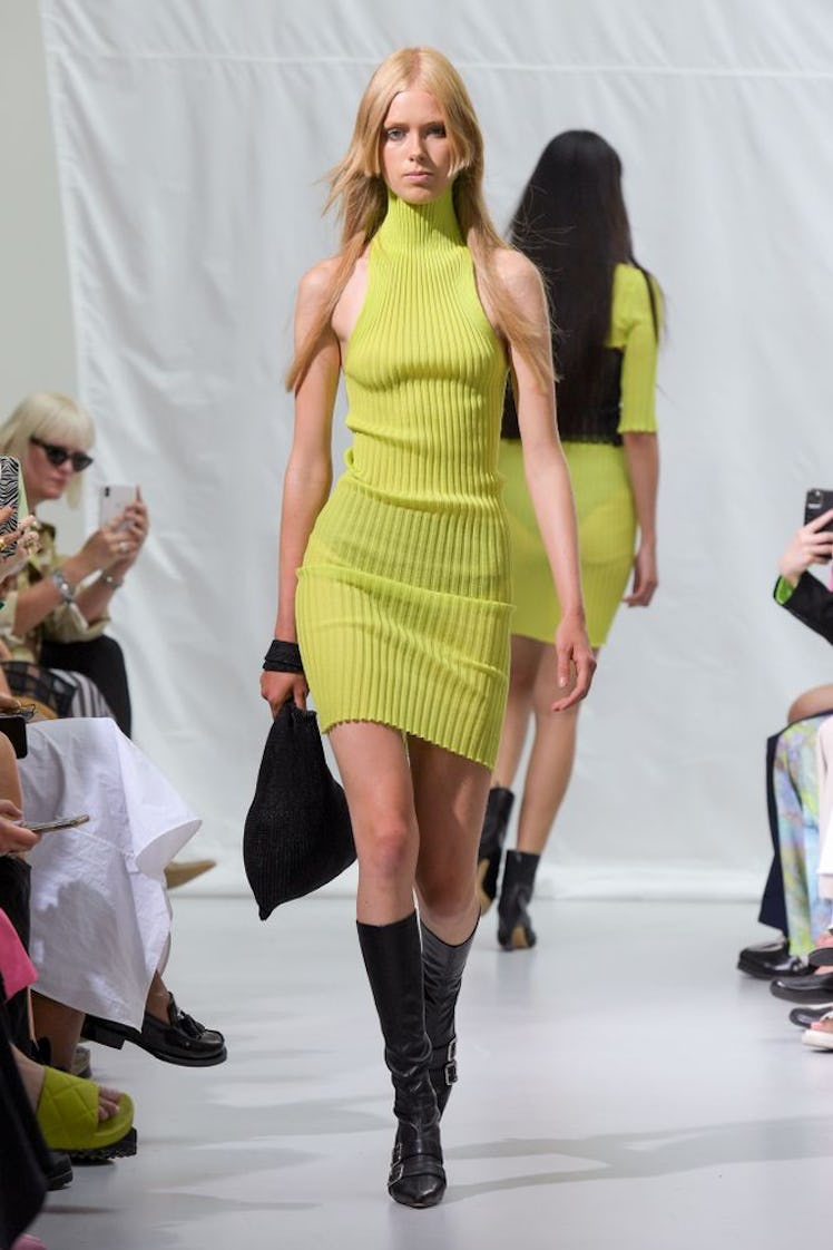 A model in a yellow ribbed dress by A Roege Hove during Copenhagen Fashion Week 