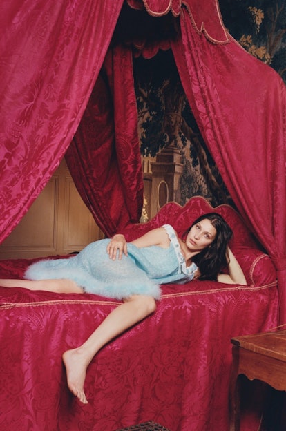 Bella Hadid reclining on a bed