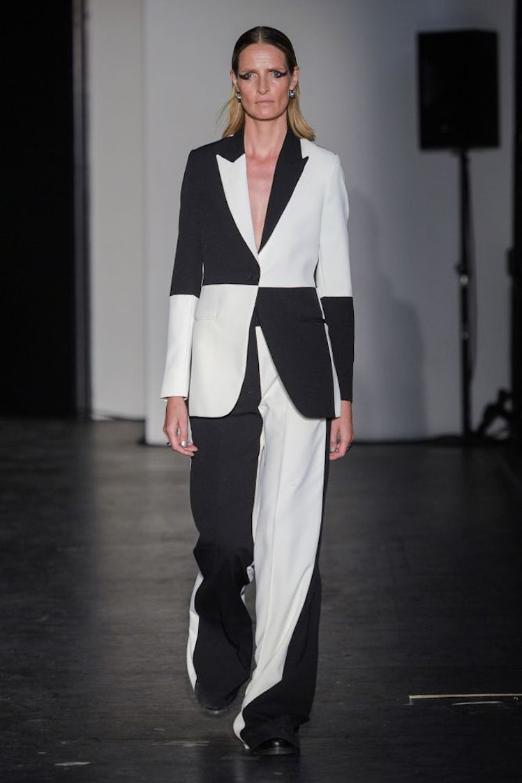 A model walking the runway in a black and white Soeren Le Schmidt suit 