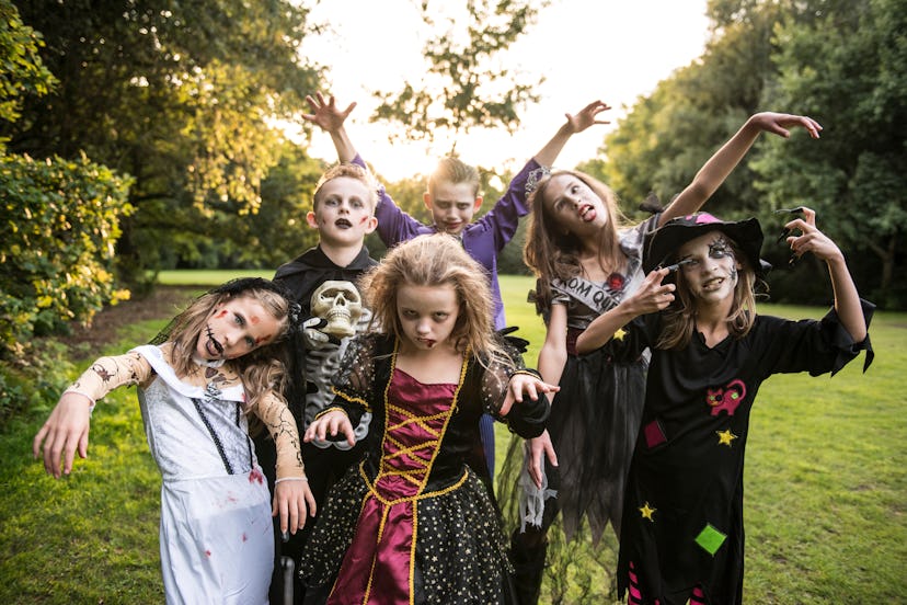 Several kids dressed as zombies, posing for camera 