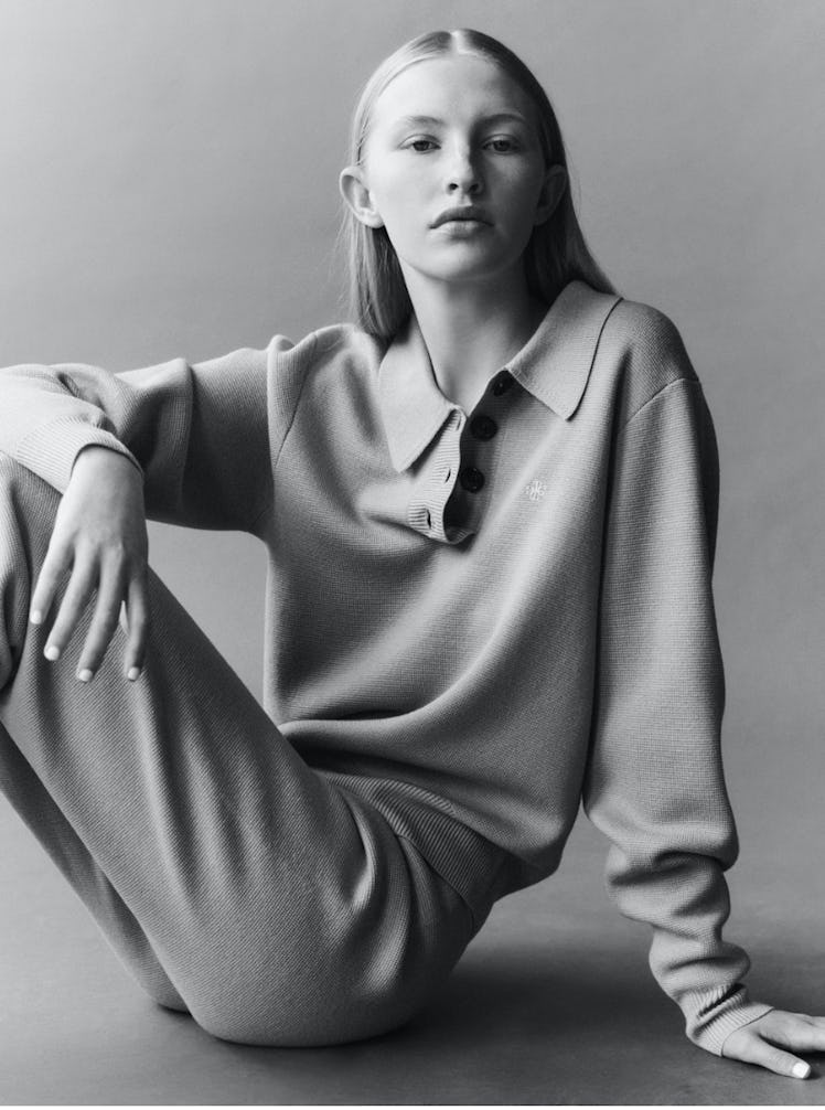 A model in a long-sleeved polo shirt and pants by The Garment 