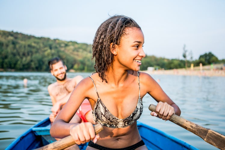Couple on boat enjoying paddling before posting on Instagram with lake captions.
