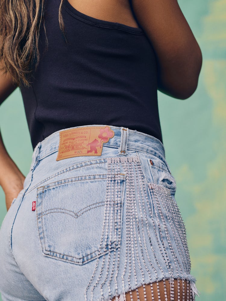 Tennis star Naomi Osaka wears crystal-embellished short denim shorts in the campaign for her Levi's ...