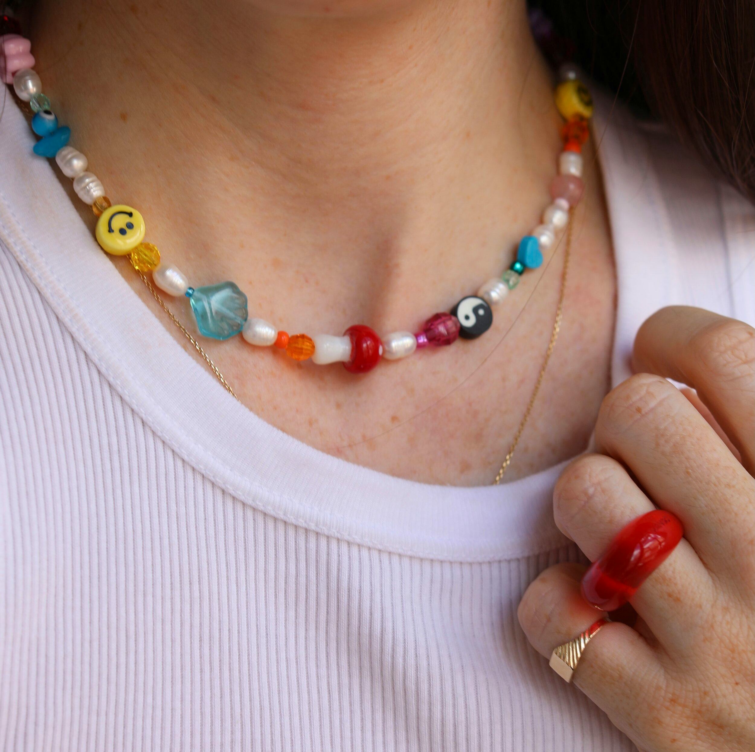 A woman wears a beaded necklace. Mindful beading is one activity in art therapy for anxiety.