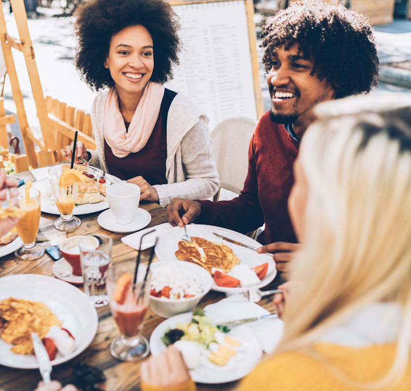 Young people having brunch before posting on Instagram with brunch captions, quotes, or puns.