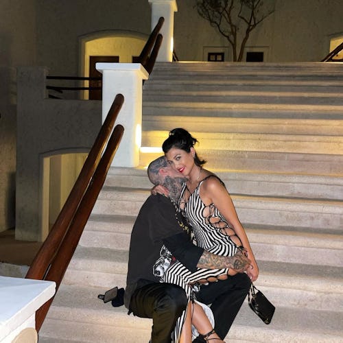 Kourtney Kardashian and Travis Barker take a photo together.