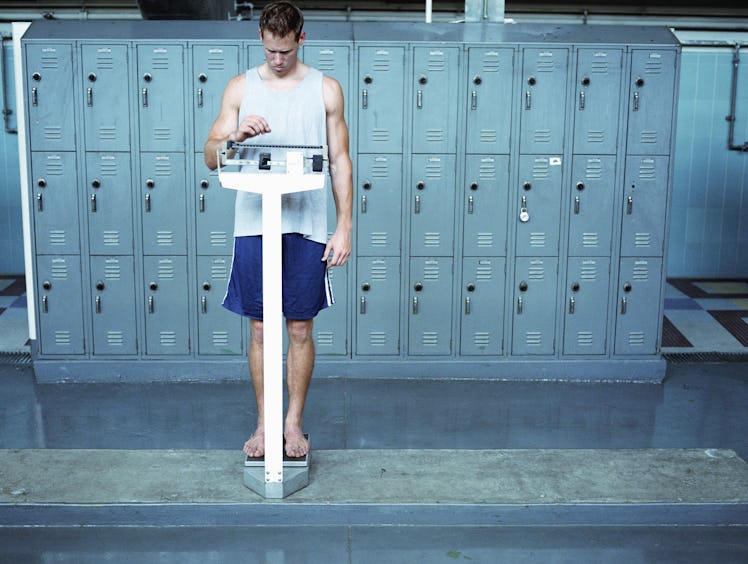 man weighing himself