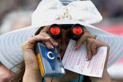 A woman holds a disposable camera. '90s technology is eerily similar to 2021's trends.