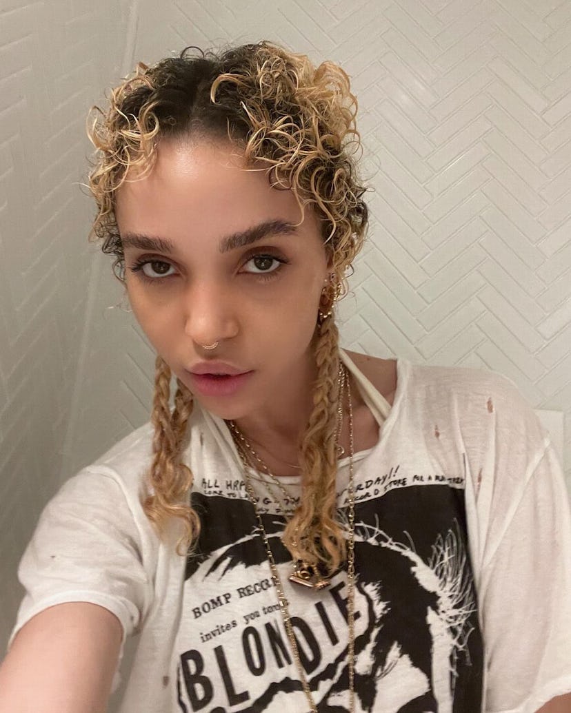 FKA Twigs wearing the braided pigtail style, a nostalgic look that's back and on-trend.