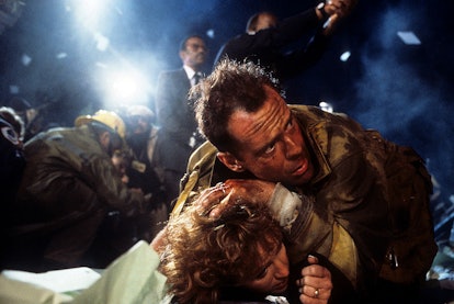 Bonnie Bedelia is held down by Bruce Willis in a scene from the film 'Die Hard.'