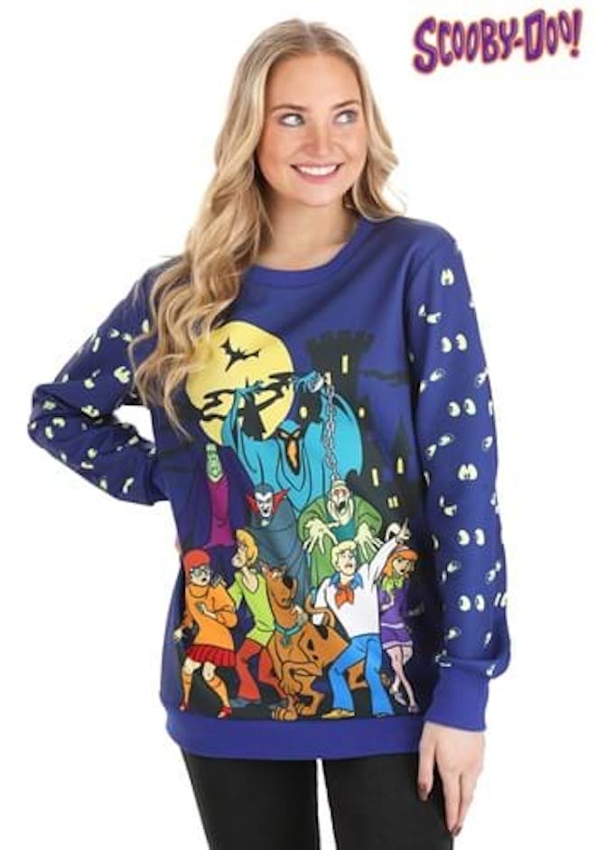 Woman wearing sweater featuring characters from the show "Scooby-Doo"