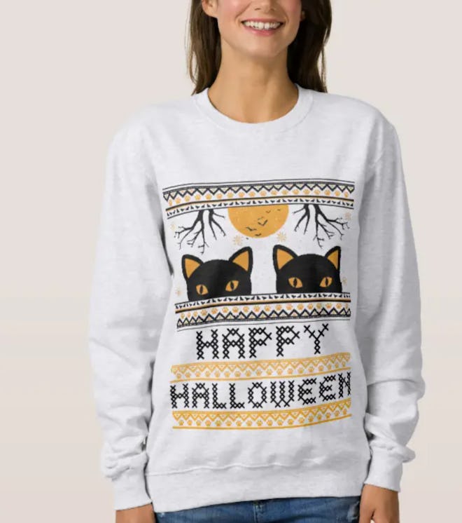 Woman in grey sweater with faux knit details with black cats