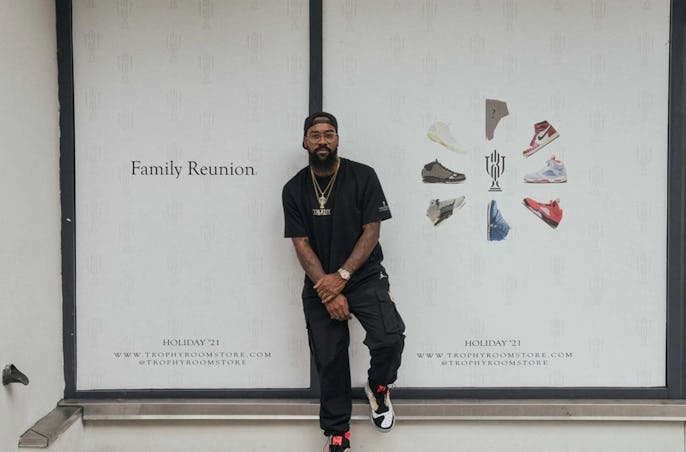 Marcus Jordan posing in front of a new Orlando Trophy Room store