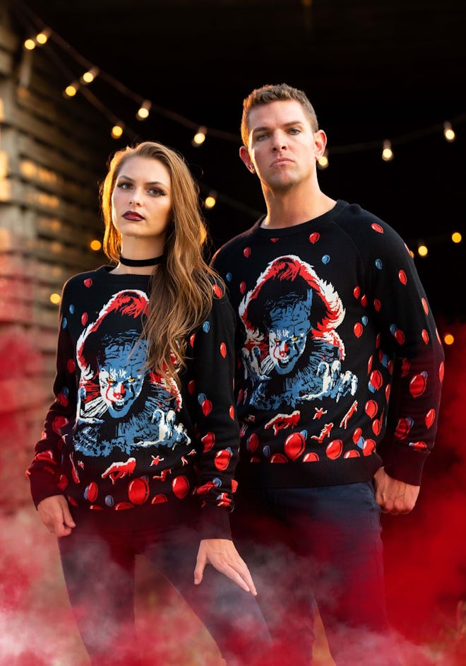 Woman and man wearing sweaters featuring Pennywise from "IT"