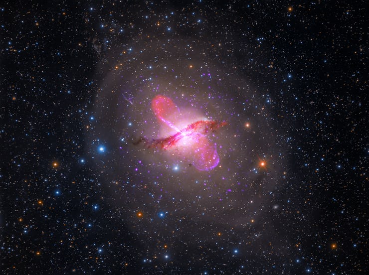 An image of Centaurus A's bright quasar, which is depicted in a spectrum of pinks and reds.