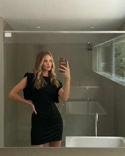 Rosie Huntington-Whiteley wears a black mini dress and poses in a mirror selfie.