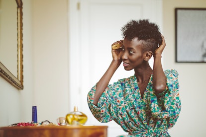 Woman brushing her hair in robe