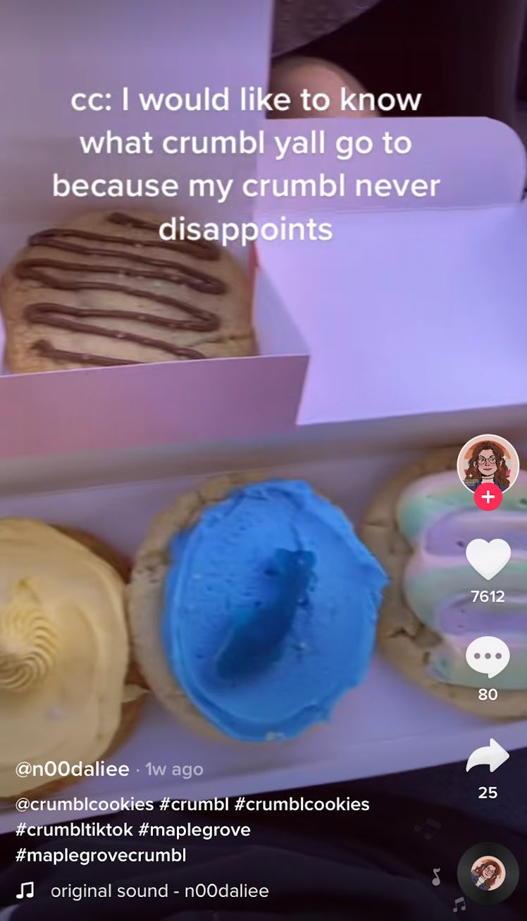 A TikToker shows off a box of Crumbl Cookies on TikTok in a review video. 