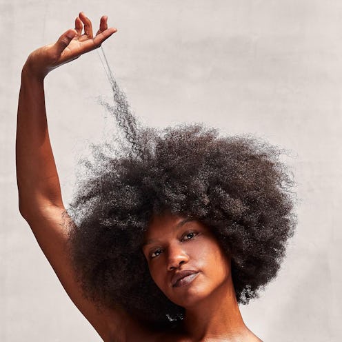 Woman touching curly hair