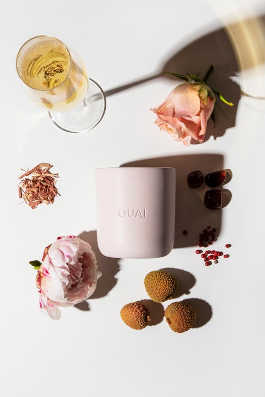 Ouai candle in Melrose Place surrounded by ingredients flat lay