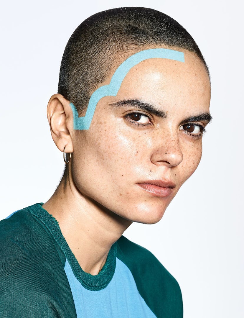 Portrait of a model with a shaved head and clear skin