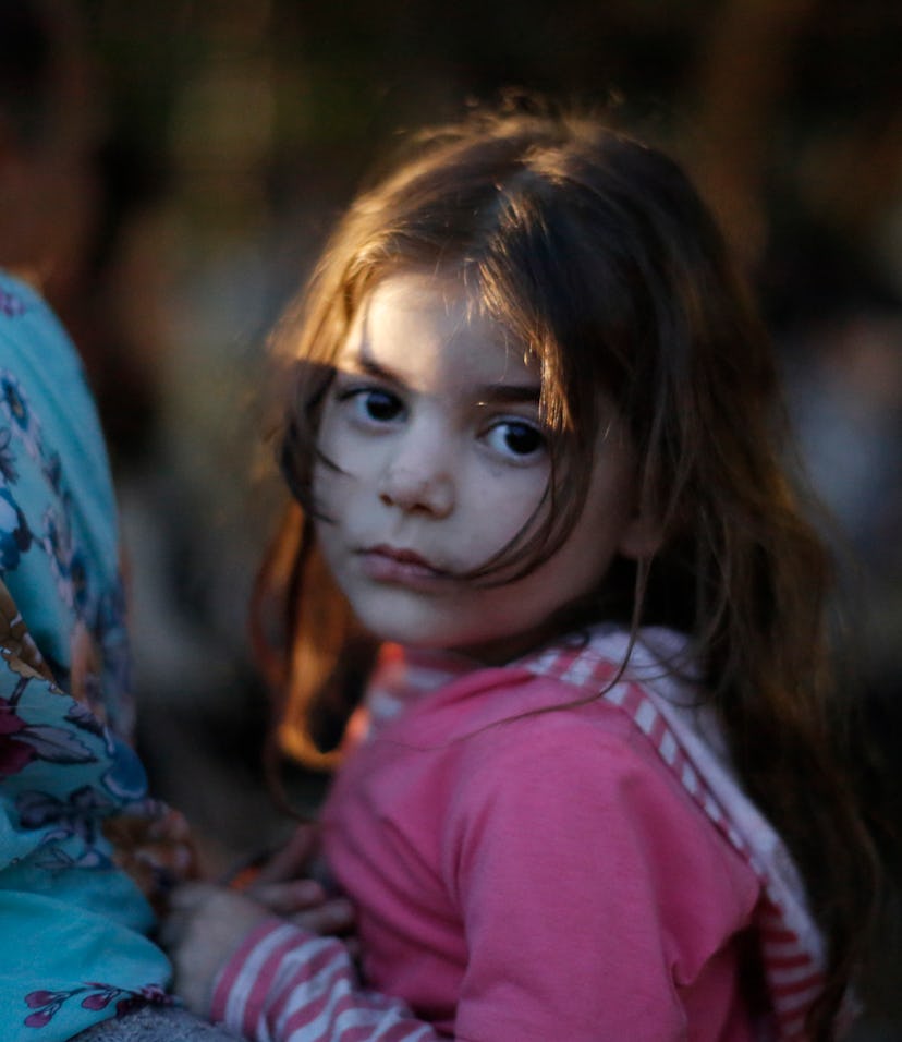 Malak, 4, and her mother wait be reunited with Mawia's father, Mahamoud Abdullah Othman, after getti...