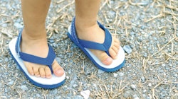 A kids feet wearing blue Flip-Flops