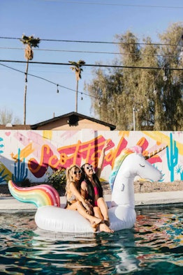 Friends sit on a pool float in the backyard of a 'Love Island'-themed Airbnb in Arizona. 