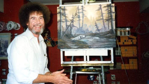 Painter Bob Ross, sitting in front of one of his paintings, partnered with Annette and Walt Kowalski...
