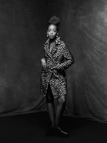 Thuso Mbedu wears a Dior coat; Prounis earrings; Prada shoes.