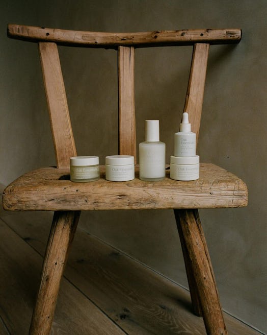 Oak Essentials skin care line arranged on wooden chair