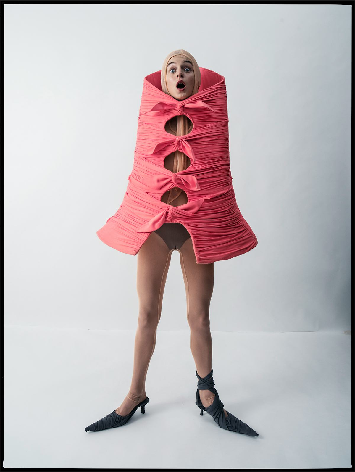 Emma Corrin wears a Kaya Chie cape, bodysuit, and shoes; stylist’s own briefs.