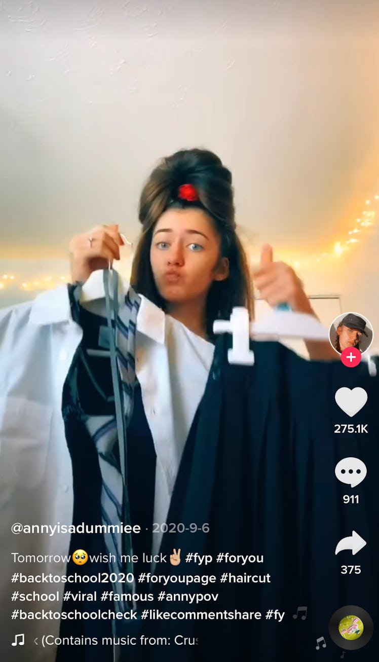 A girl gets ready for school and shows off her uniform in a POV back-to-school TikTok video. 